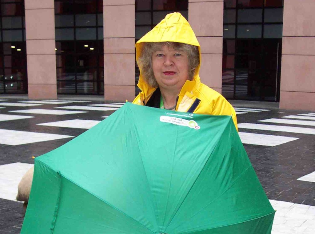 Jean with umbrella and raincoat at a climate demonstration