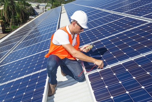 Solar panels being fitted on a roof