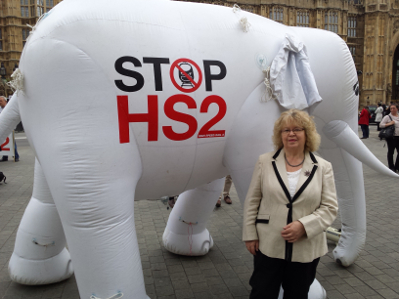 Jean outside the House of Commons with a white elephant representing the HS2 proposals
