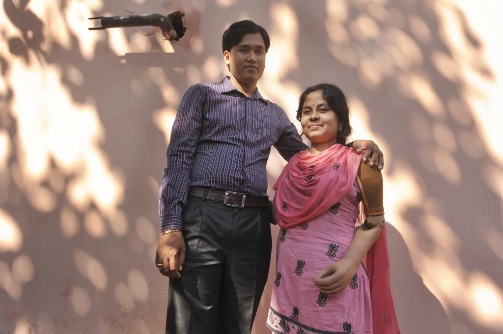 Garment worker Laboni, stands with her husband, she lost her left hand at Rana Plaza collapse.